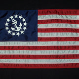 US Yacht Ensign Nylon Embroidered and Sewn Flag 12 x 18 with white anchor and stars on blue fabric, brass grommets, and strong header.