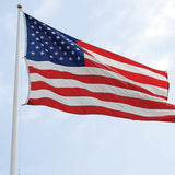 American flag flying on a pole against a blue sky, emphasizing its large 20x38 ft size and detailed appliqued stars and sewn stripes.