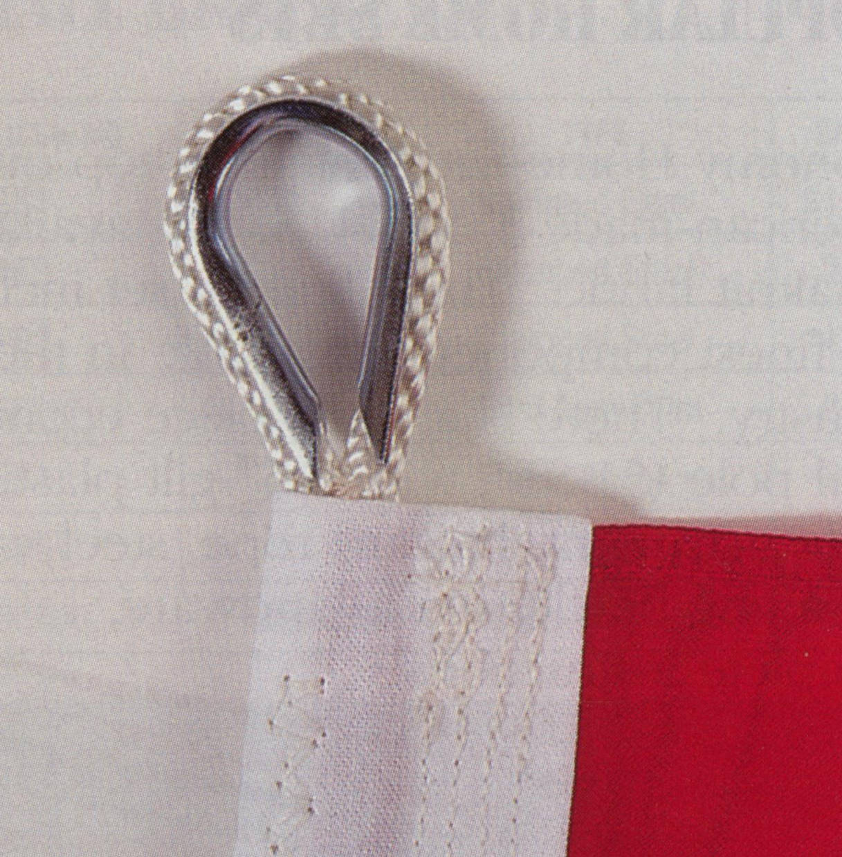 Close-up of a 12x18 ft American Flag with embroidered stars, sewn stripes, and a strong hook for hanging.