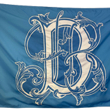 Blue flag with a white letter B, made of UV-resistant nylon, featuring brass grommets and a strong header, for custom SEWN applique designs.