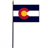 Colorado Stick Flag - 4 x 6 Desktop Flag featuring a red circle and blue stripes, mounted on a 10.5 plastic stick with a gold spear finial.