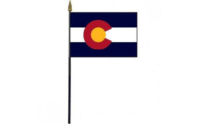 Colorado Stick Flag - 4 x 6 Desktop Flag featuring a red circle and blue stripes, mounted on a 10.5 plastic stick with a gold spear finial.