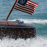 US Yacht Ensign Nylon Embroidered and Sewn Flag 16 x 24 on a boat, featuring a fouled anchor in a circle of stars.