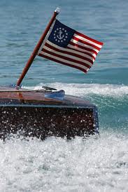 US Yacht Ensign Nylon Embroidered and Sewn Flag 16 x 24 on a boat, featuring a fouled anchor in a circle of stars.