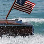 US Yacht Ensign Nylon Embroidered and Sewn Flag 12 x 18 displayed on a boat, showing its strong header and brass grommets.