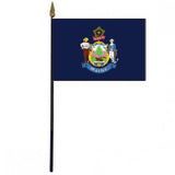 Maine Stick Flag - 4 x 6 Desktop Flag mounted on a 10.5 plastic stick with gold spear finial, featuring a coat of arms with two men holding axes.