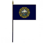 New Hampshire Stick Flag - 4 x 6 Desktop Flag featuring a blue and yellow seal with a ship, mounted on a plastic stick with a gold spear finial.