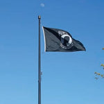 US Military POW/MIA Flag Printed Nylon 3' x 5' Single Sided featuring a white face and circle on a black background, mounted on a pole.