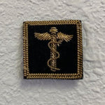 Fleet Surgeon Yacht Club Officer Insignia Pin featuring a caduceus symbol, gold bullion thread on black felt, with a pin back for secure attachment.