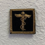 Fleet Surgeon Yacht Club Officer Insignia Pin featuring a caduceus symbol, gold bullion thread on black felt, with a pin back for secure attachment.