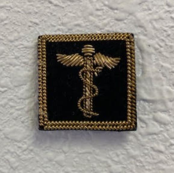 Fleet Surgeon Yacht Club Officer Insignia Pin featuring a caduceus symbol, gold bullion thread on black felt, with a pin back for secure attachment.