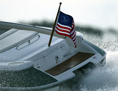 US Yacht Ensign Nylon Embroidered and Sewn Flag 16 x 24 displayed on a boat's stern, showing a fouled anchor within a circle of stars.