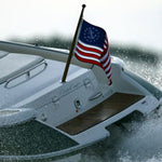 US Yacht Ensign Nylon Embroidered and Sewn Flag 12 x 18 displayed on a boat, featuring a fouled anchor in a circle of stars.